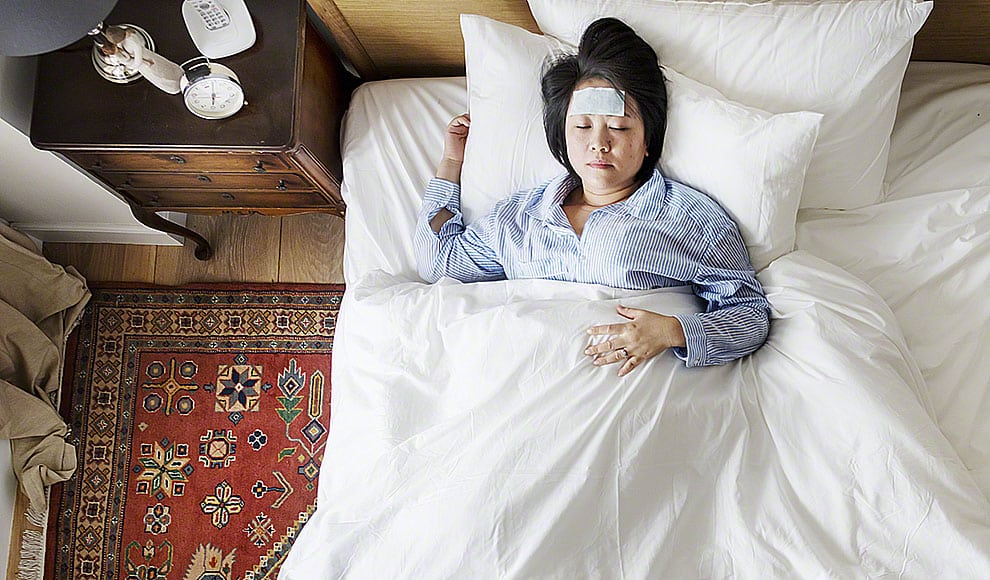 Sick Asian woman with fever sleeping on the bed | Iretimn